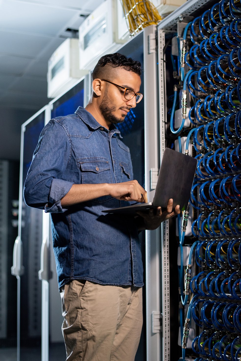 Concentrated network engineer examining database server